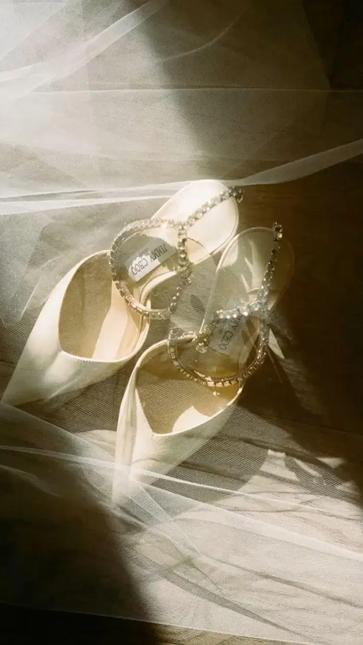 Bridal shoes resting on tulle in the morning light