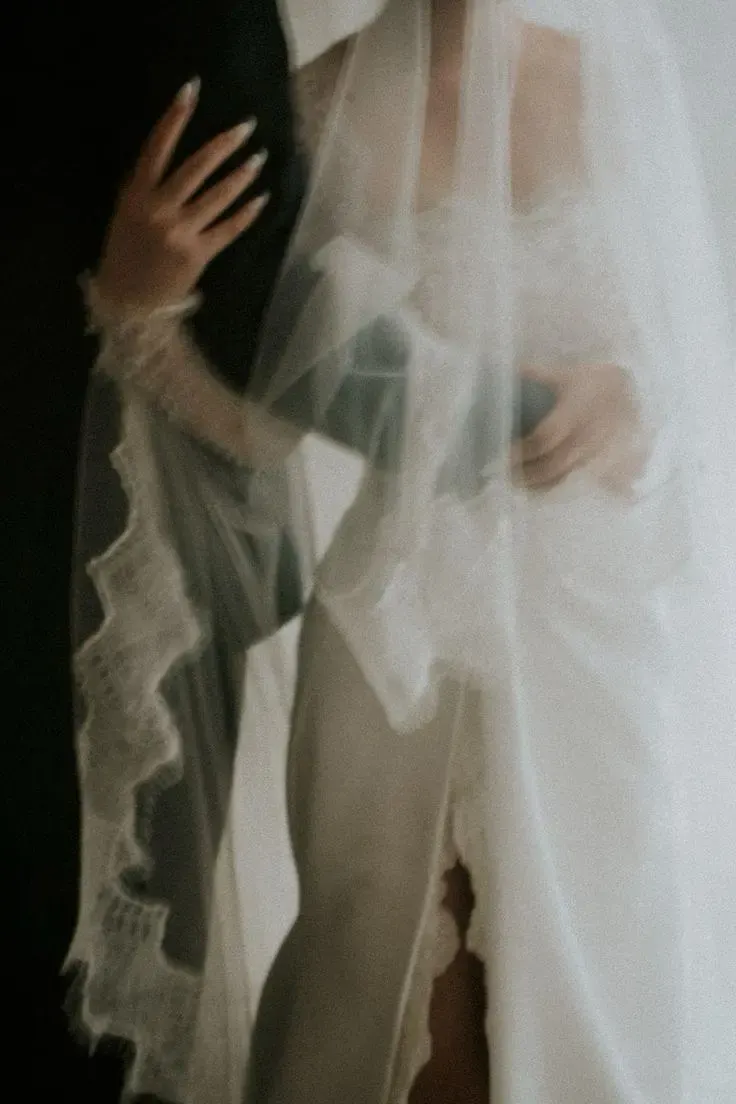 Lace veil and bridal gown in soft light